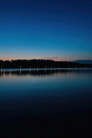 Night landscape with starry sky and lake. Long exposure photo.の素材