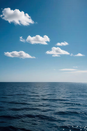 Blue sky with white clouds and sea water surface. Natural background.の素材