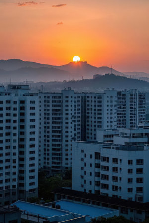 Sunset over the city of Seoul, South Korea. The sun is setting behind the buildings.の素材