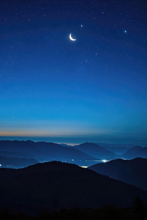 Moon and stars in the night sky over the mountains. Beautiful landscape.の素材