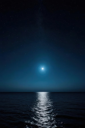 The moon in the night sky over the sea and the starry skyの素材