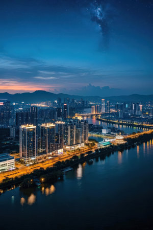 Aerial view of Hong Kong city at night with urban architecture and riverの素材