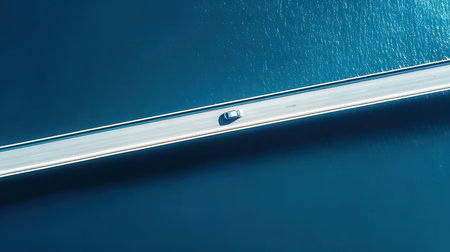 Close-up of a stainless steel door handle on a blue backgroundの素材