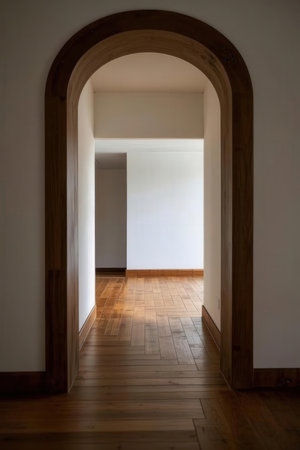 Interior of an empty room with a wooden door and a white wallの素材