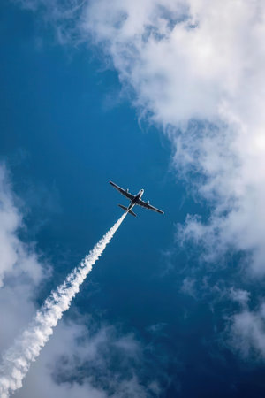 Airplane in the blue sky with white clouds. Photo for your designの素材