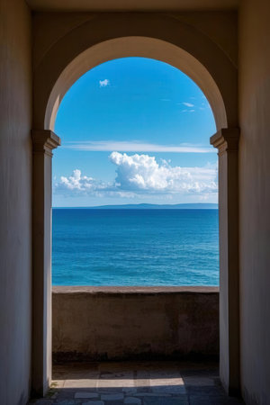 View of the sea through the arched window of the building.の素材