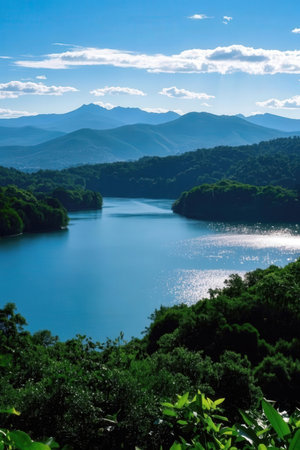 Landscape of a lake with mountains and blue sky in the backgroundの素材