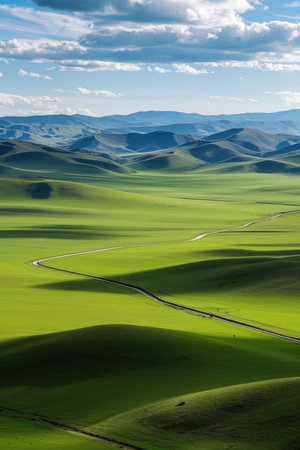 Beautiful landscape of grassland in Xinjiang, China. Green hills and blue sky.の素材
