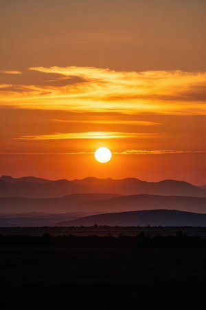 Sunset in the desert of Namibia with mountains in the backgroundの素材