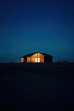 Wooden house in the middle of the snow in the evening.の素材