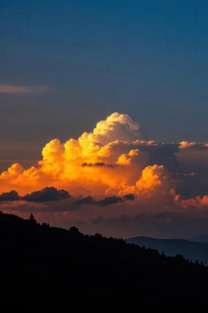 Sunset in the mountains with clouds and sun rays in the skyの素材