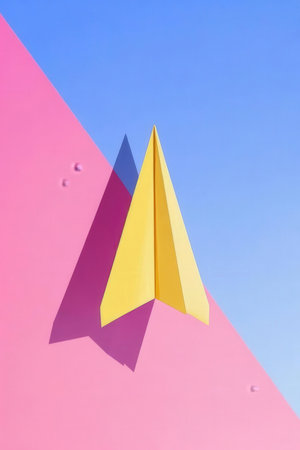 Paper plane on a pink and blue background. Minimal concept.の素材