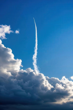 Airplane trail in the blue sky with white clouds, concept of freedomの素材