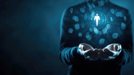 Businessman holding virtual icon of a man in his hands on dark backgroundの素材