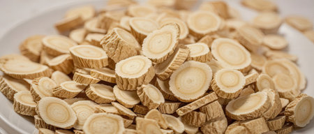 Close up of a pile of shortbread cookies in white plate.の素材