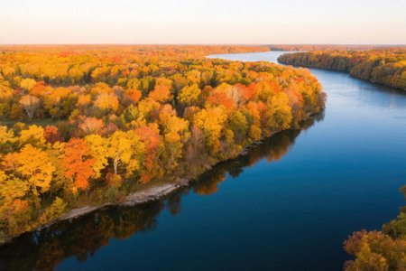Aerial view of autumn forest and river. Colorful trees in autumn.の素材