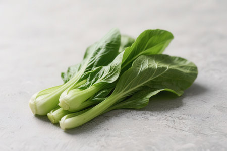 Fresh green bok choy on light textured background, closeupの素材