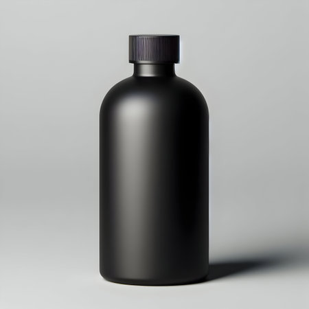 Mockup of a black plastic bottle with cap on a gray backgroundの素材