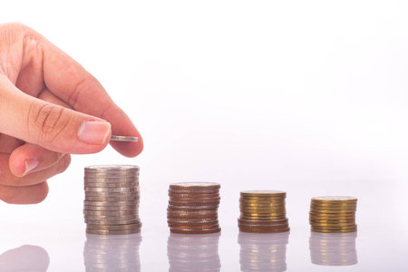 Saving money concept,Male hand putting money coin stack growing business