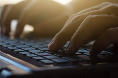 Close up shot of a man's hand typing on the computer keyboard.の写真素材
