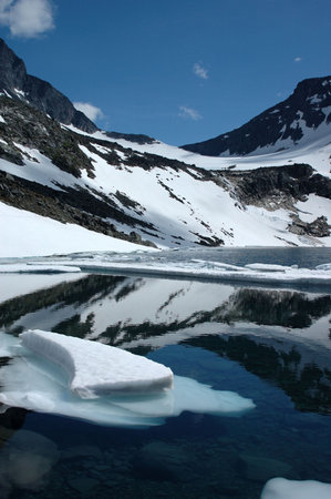 Lake with floating ice in mountains of Norway