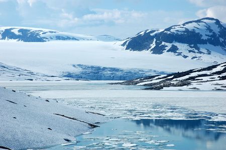 Lake with floating ice in mountains of Norwayの写真素材