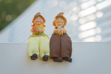 Lover dolls boy and girl sit with smile together