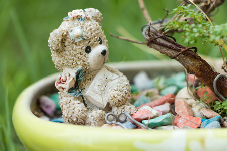 Close up teddy bear mini sit on colorful stoneの写真素材