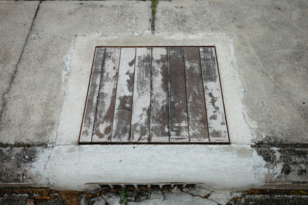 Create a manhole cover on the street walking by myselfの写真素材