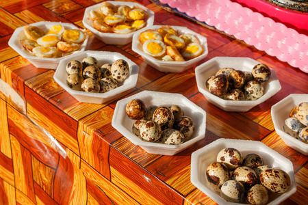 Fresh fried quail eggs. Traditional thai walking street food cuisine.の写真素材