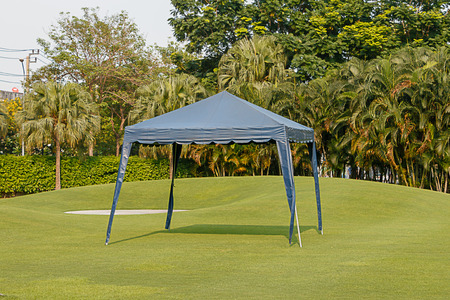 The blue outdoor tent in a field on top grass for protect sunlightの写真素材