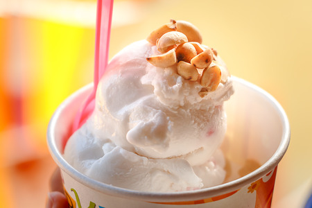 Close up hold the vanilla and peanut in ice cream cup, Selective focusの写真素材