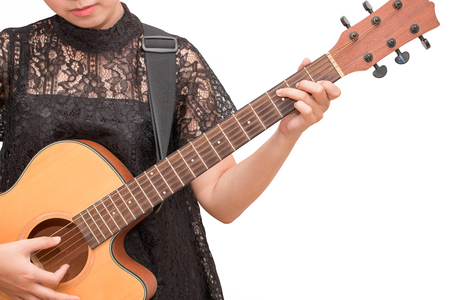 A woman playing acoustic guitar by chord C on isolated white backgroundの写真素材