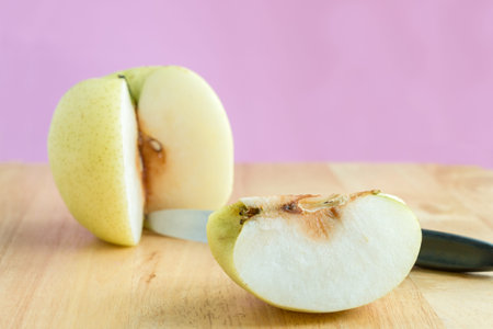 Cut into pieces chinese pear fruit on the wooden boardの写真素材