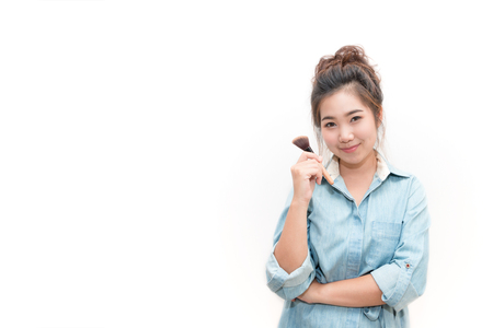 Portrait of Asian Beautiful woman handle blush brush on white backgroundの写真素材