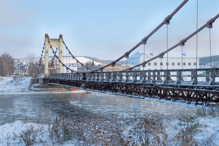 Winter snow morning on the river with the bridgeの写真素材