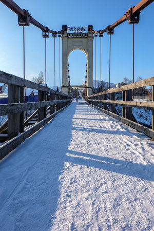 Morning photo of the bridge for pedestrians with the snowの写真素材