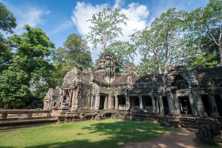 View of an ancient stone door with clear blue sky, Ta Prohm temple ruins, Angkor, Cambodia.の写真素材