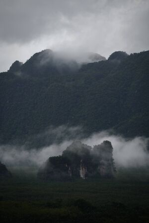 Close-up scene of the fog over the mountain in sunset time at Krabi province, Thailand.の写真素材