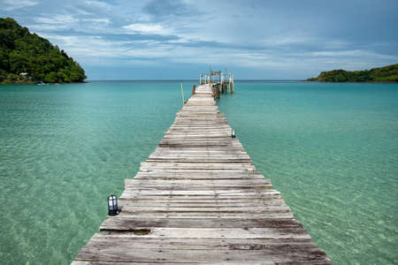 The scenery of the clear seawater and wooden bridge at Koh Kood island in Trat province, Thailand.の写真素材