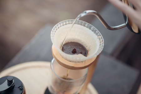Hand drip coffee, Barista pouring water on the coffee ground with filter.の写真素材
