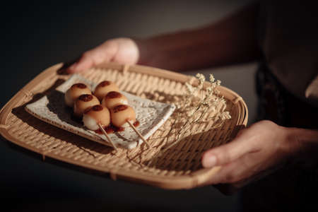 Roasted Mitarashi Dango in the wooden tray, one of the most popular Japanese street food.の写真素材