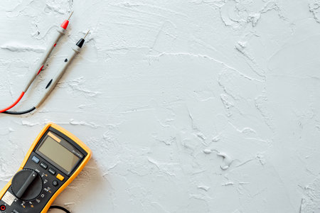Yellow Digital multimeter with probes on white background with free copy space.の写真素材