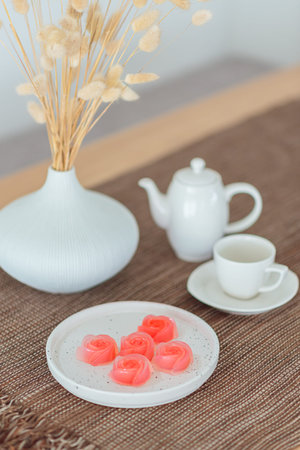 Pink jelly desserts with a set of tea on the table. (selective focus)