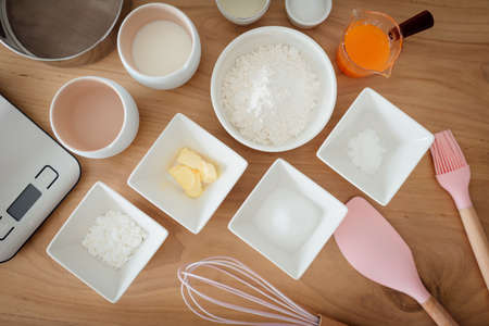 A set of ingredients and tools for baking an orange cake.の写真素材