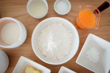 A set of ingredients and tools for baking an orange cake.の写真素材