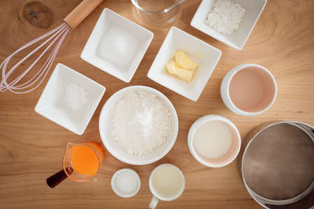A set of ingredients and tools for baking an orange cake.の写真素材