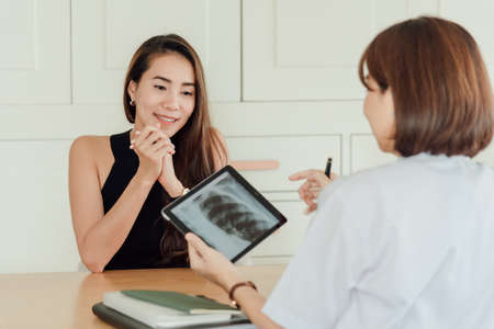 A female patient in a glad moment after knowing the good news of treatment.の写真素材
