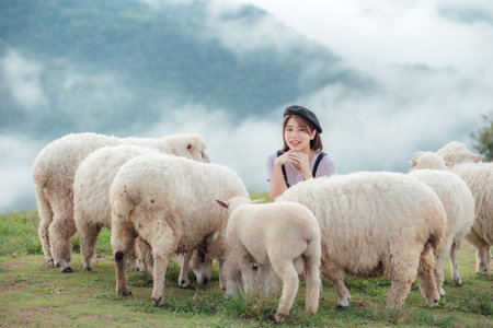 A happy moment of a female farmer and her sheep.の写真素材