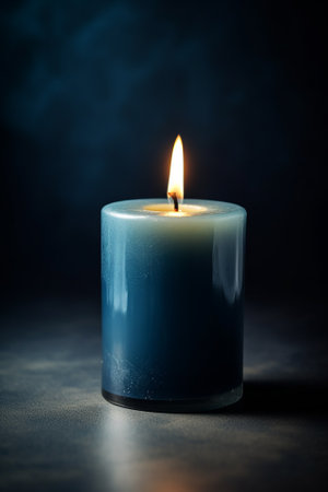 Burning candle on a dark background. Shallow depth of field.の素材